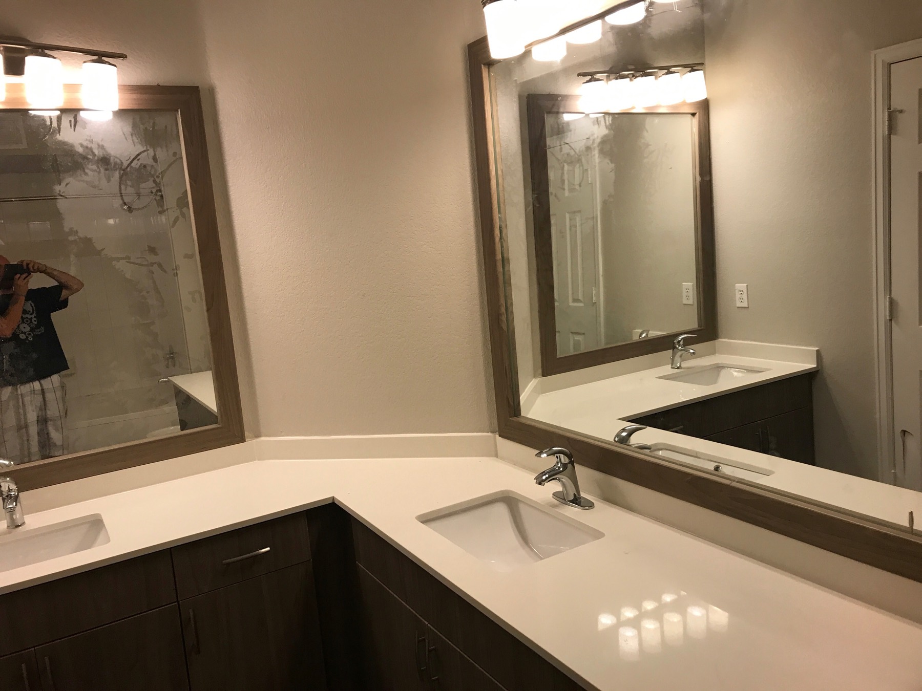 Bathroom vanity with framed mirrors and stone counter